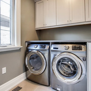 Design ideas for a medium sized traditional single-wall separated utility room in Toronto with a submerged sink, shaker cabinets, white cabinets, zinc worktops, beige walls, porcelain flooring and a side by side washer and dryer.