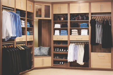 Design ideas for a large transitional gender-neutral walk-in wardrobe in Columbus with open cabinets, medium wood cabinets and carpet.