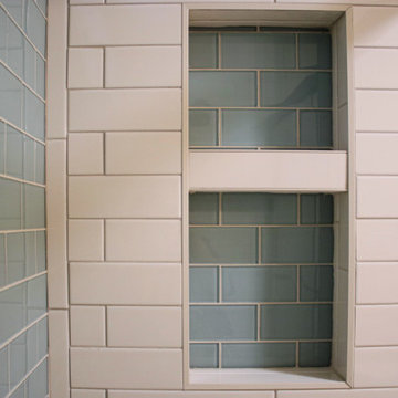 Guest Bathroom with Cherry Vanity, Venetia Cream Countertop, Tiled Shower Walls