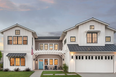 Large cottage white two-story concrete fiberboard exterior home photo in San Diego with a metal roof