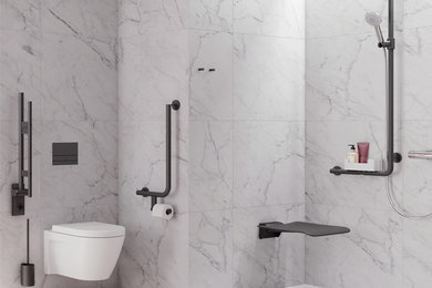 Mid-sized contemporary wet room bathroom in Auckland with a wall-mount toilet, white tile, marble, white walls, ceramic floors, brown floor, an open shower and a single vanity.