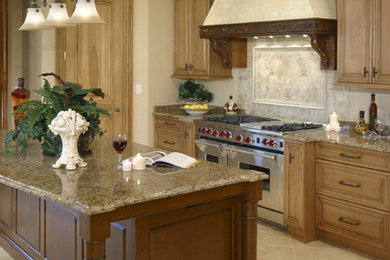 This is an example of a traditional kitchen in Chicago with raised-panel cabinets, light wood cabinets, granite benchtops, beige splashback, porcelain splashback, porcelain floors, with island and beige floor.