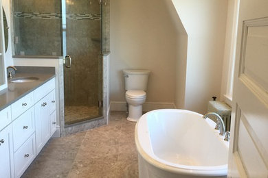 Inspiration for a transitional master bathroom in Bridgeport with shaker cabinets, dark wood cabinets, porcelain tile and light hardwood floors.