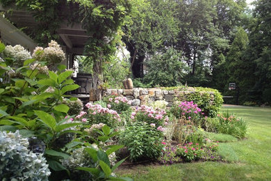 Design ideas for a mid-sized traditional partial sun backyard concrete paver landscaping in New York.