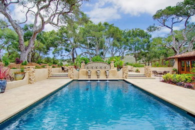 This is an example of a large mediterranean backyard rectangular lap pool in San Francisco with a hot tub and natural stone pavers.