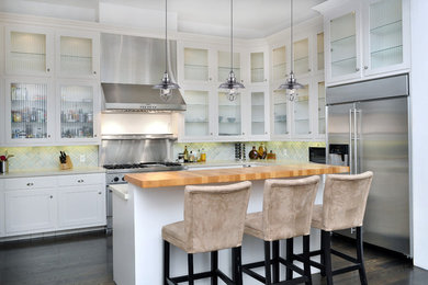 Inspiration for a mid-sized contemporary l-shaped dark wood floor and brown floor kitchen remodel in Detroit with an undermount sink, shaker cabinets, white cabinets, solid surface countertops, blue backsplash, ceramic backsplash, stainless steel appliances and an island