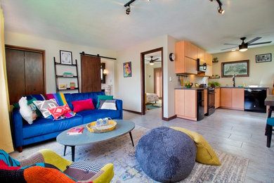 Example of a small minimalist open concept gray floor living room design in Other with white walls, a wood stove and a wall-mounted tv