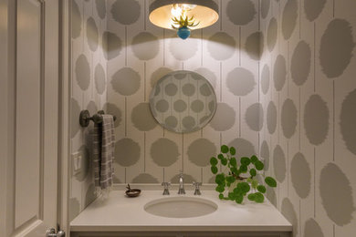 Inspiration for a small contemporary powder room in Boston with shaker cabinets, grey cabinets, engineered quartz benchtops, white benchtops, an undermount sink and wallpaper.