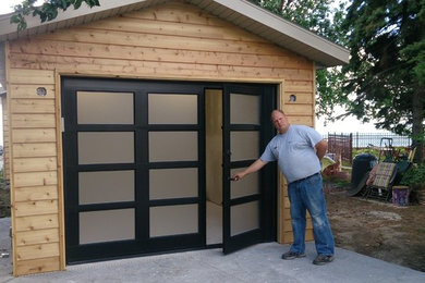 Example of a trendy attached three-car carport design in Other