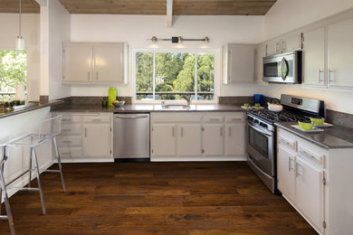 Inspiration for a timeless medium tone wood floor kitchen remodel in Other
