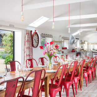 This is an example of a large country open plan dining room in Cornwall with white walls and painted wood flooring.