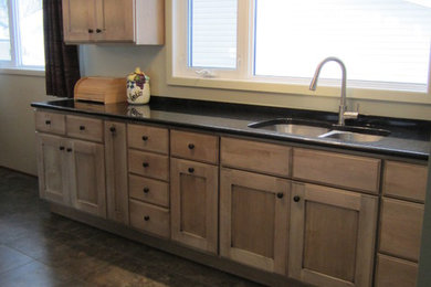 Inspiration for a mid-sized craftsman u-shaped ceramic tile and gray floor eat-in kitchen remodel in Toronto with shaker cabinets, a double-bowl sink, light wood cabinets, quartzite countertops, white appliances and no island