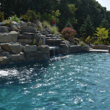 Custom Freeform style salt water in ground pool with Waterslide and Spa
