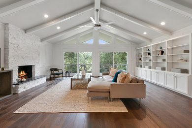 Example of a large transitional open concept dark wood floor living room library design in Austin with gray walls, a standard fireplace, a stone fireplace and a tv stand