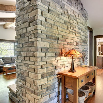 Weathered Antique Box Beams with a Stone Fireplace in a Traditional Living Room