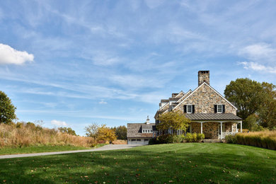 Farmhouse two-story stone gable roof photo in Philadelphia