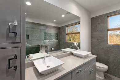 Mid-sized farmhouse master gray tile medium tone wood floor and gray floor bathroom photo in Other with beaded inset cabinets, beige cabinets, white walls, a drop-in sink, granite countertops and a hinged shower door