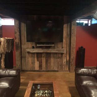 Large rustic fully buried basement in Other with red walls, concrete flooring, no fireplace and brown floors.