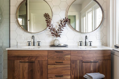 This is an example of a mid-sized midcentury master bathroom in Portland with medium wood cabinets, white tile, ceramic tile, white walls, porcelain floors, an undermount sink, engineered quartz benchtops, black floor, a hinged shower door, white benchtops, a niche, a double vanity and a floating vanity.