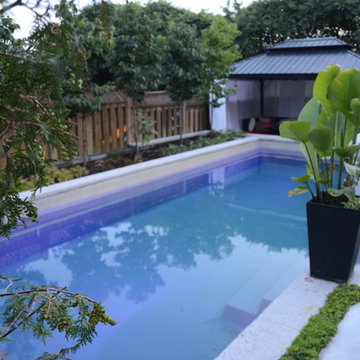 Modern Landscape with Fiberglass Pool, slab patio, water feature and more!