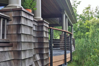 Inspiration for a large backyard deck in Seattle with a roof extension.