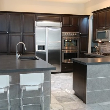 New kitchen island and countertops, stone base with metal trim