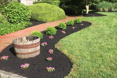 This is an example of a small traditional full sun front yard brick landscaping in New York for summer.