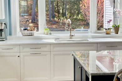Inspiration for a huge transitional l-shaped medium tone wood floor and brown floor kitchen pantry remodel in Boston with an undermount sink, shaker cabinets, white cabinets, quartz countertops, blue backsplash, mosaic tile backsplash, stainless steel appliances, an island and white countertops
