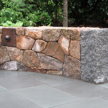 New England fieldstone wall with antique granite end post.