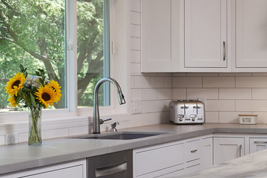 Inspiration for a contemporary eat-in kitchen remodel in Minneapolis with a single-bowl sink, white cabinets, concrete countertops, white backsplash, subway tile backsplash, stainless steel appliances, an island and multicolored countertops