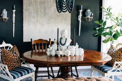 Eclectic medium tone wood floor and black floor enclosed dining room photo in Minneapolis with black walls