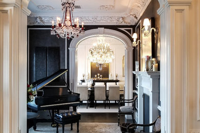 Inspiration for a mid-sized timeless dark wood floor and black floor foyer remodel with black walls