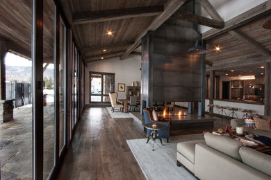 Huge trendy open concept light wood floor living room photo in Salt Lake City with a two-sided fireplace