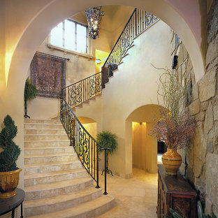 Inspiration for a classic u-shaped metal railing staircase in Austin with travertine treads and travertine risers.