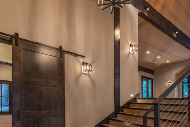 Example of a mountain style wooden metal railing staircase design in Sacramento with wooden risers