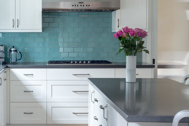 Example of a transitional kitchen design in Los Angeles with blue backsplash, glass tile backsplash and an island