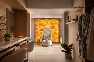 Mid-sized trendy walk-out ceramic tile, beige floor and wallpaper basement photo in New York with beige walls