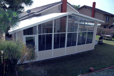 Example of a mid-sized classic backyard brick patio design in Orange County