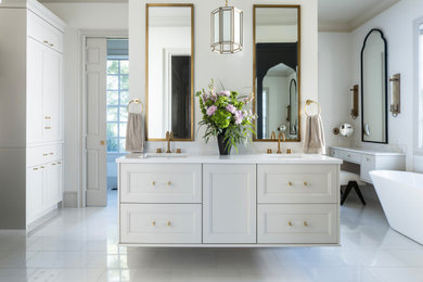 Example of a large classic master ceramic tile porcelain tile, white floor and double-sink bathroom design in Other with recessed-panel cabinets, beige cabinets, a one-piece toilet, white walls, an undermount sink, quartzite countertops, a hinged shower door and a floating vanity