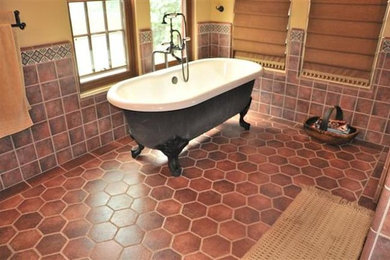 Mid-sized terra-cotta tile freestanding bathtub photo in San Diego with yellow walls