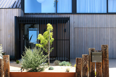 Design ideas for a contemporary house exterior in Geelong with wood siding.