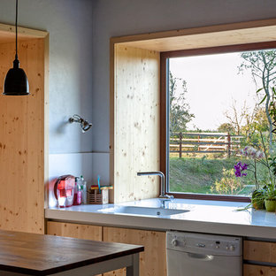 Mid-sized farmhouse kitchen pantry pictures - Mid-sized cottage galley terra-cotta floor kitchen pantry photo in Nantes with an undermount sink, beaded inset cabinets, light wood cabinets, solid surface countertops, white backsplash and an island