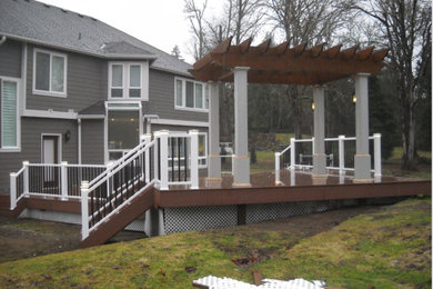 Mid-sized arts and crafts backyard deck photo in Seattle with a pergola
