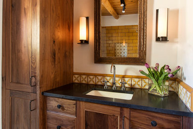 This is an example of a small mediterranean 3/4 bathroom in Albuquerque with shaker cabinets, dark wood cabinets, an open shower, yellow tile, subway tile, terra-cotta floors, an undermount sink and engineered quartz benchtops.