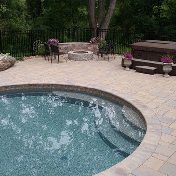 Oasis free form vinyl pool with paver deck
