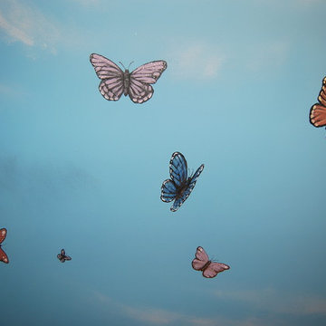 Sky Ceiling Mural with Butterflies, hand-painted in a bedroom by Mural Art LLC.