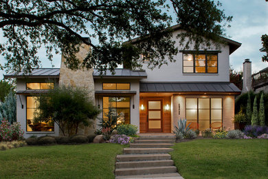 Inspiration for a mid-sized transitional two-story gable roof remodel in Austin with a metal roof