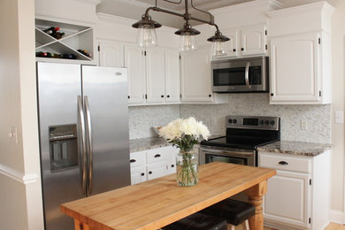 Mid-sized u-shaped light wood floor open concept kitchen photo in Other with a farmhouse sink, white cabinets, granite countertops, white backsplash, mosaic tile backsplash, stainless steel appliances and an island
