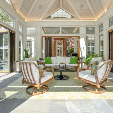 Cabana interior with glass folded open to the pizza oven and outdoor kitchen