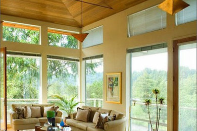 Inspiration for a mid-sized mid-century modern open concept medium tone wood floor and brown floor family room remodel in San Francisco with beige walls